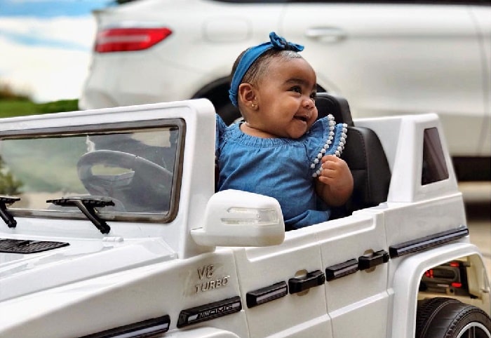 Reign Ryan driving her Mercedes Benz toy.